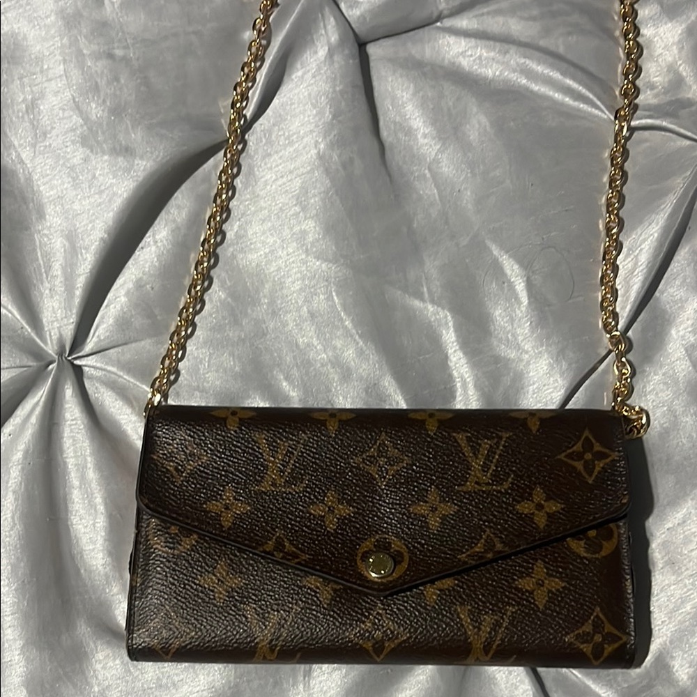 LV wallet with pink interior.